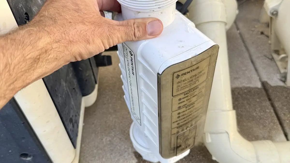pool-heater-repair-technician-riverside - Pool Time Pool Time technician servicing pool equipment on the pad in Riverside, CA